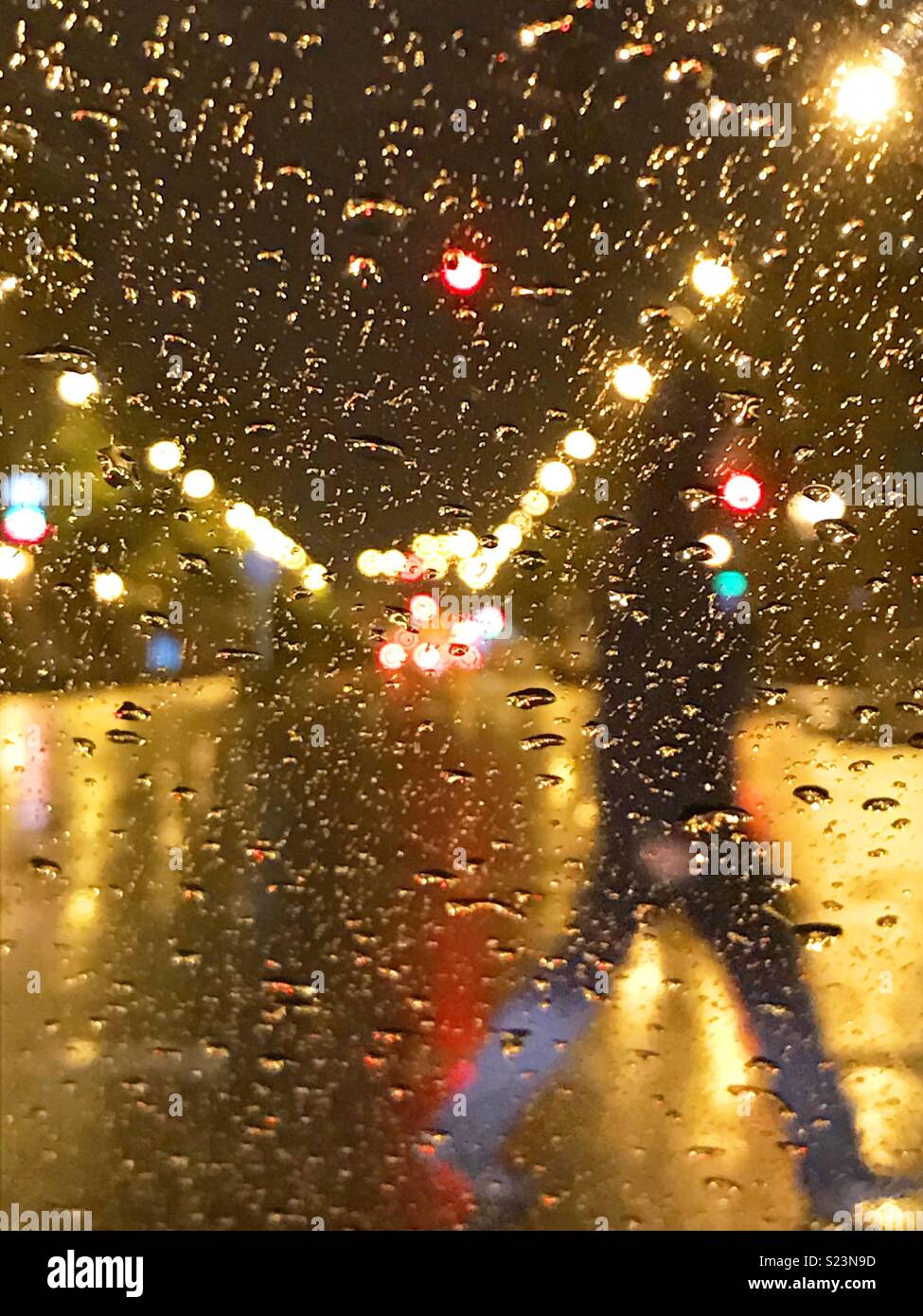 View through  a wet window in a rainy night. Stock Photo