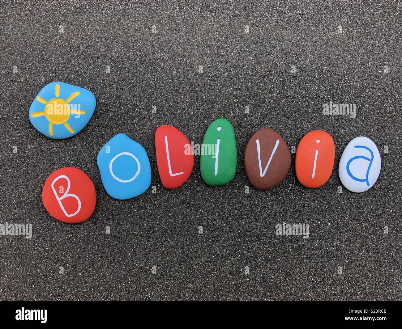 Bolivia, souvenir with multicolored stones over black volcanic sand - Smartphone Captured Stock Image