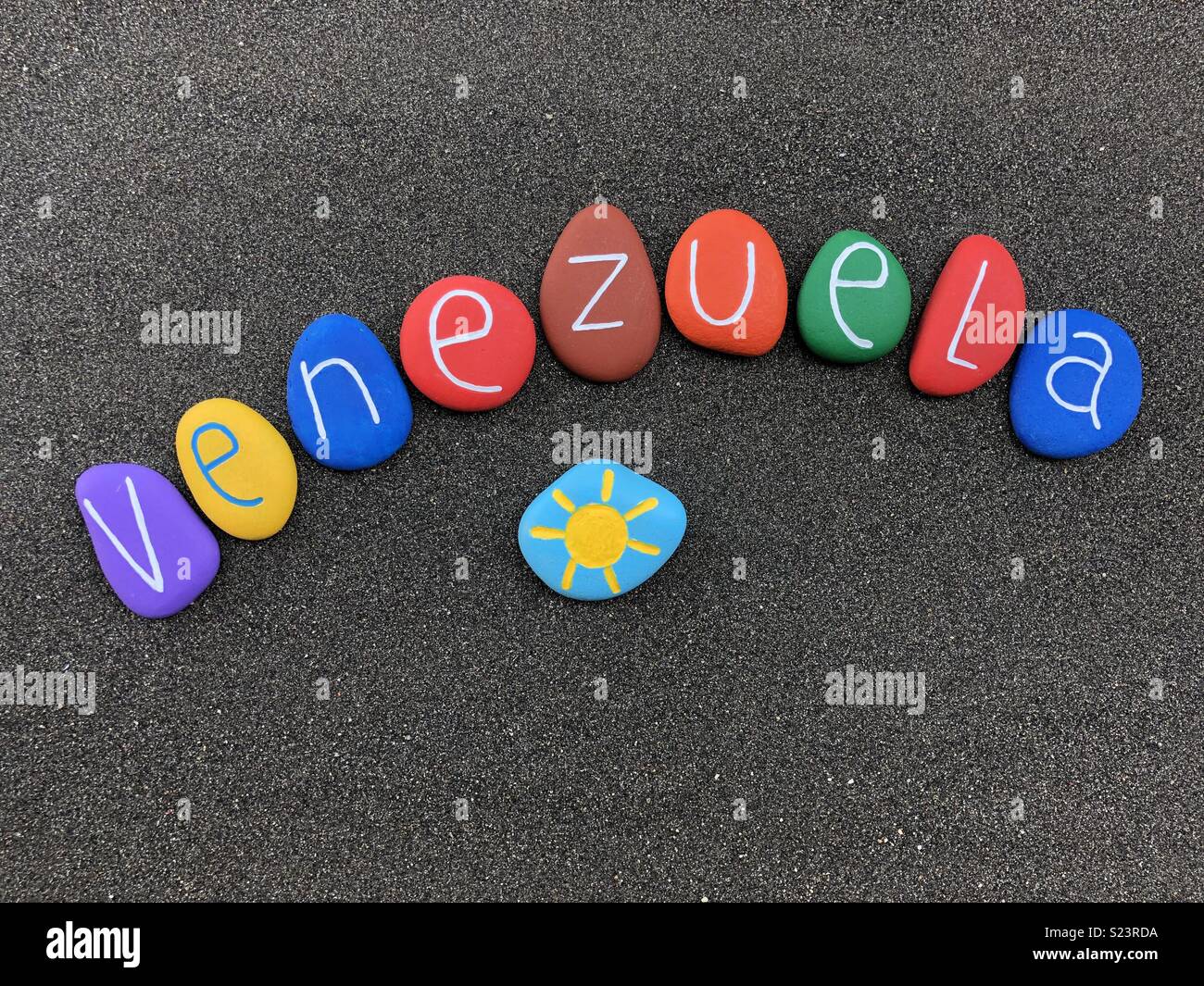 Venezuela, souvenir with multicolored stones over black volcanic sand - Smartphone Captured Stock Image