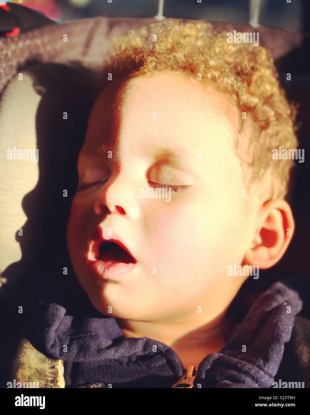 Catching flies. Little boy naps in car Stock Photo