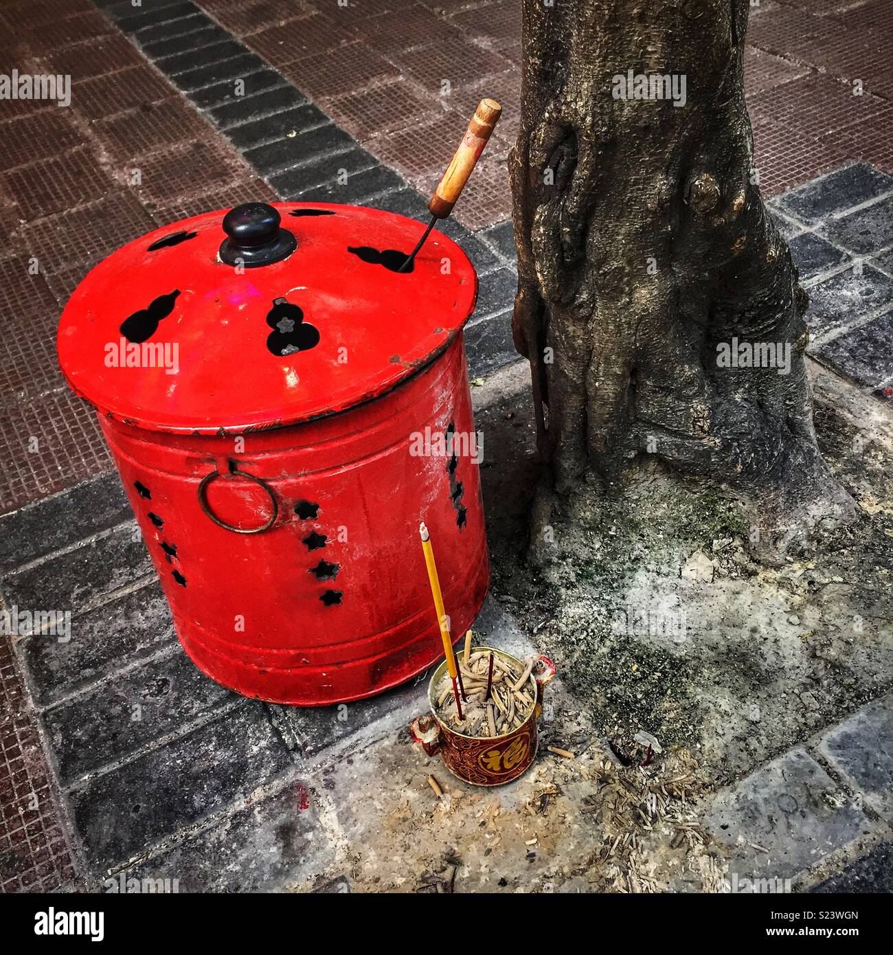 Incense and a brazier for burning joss paper outside a shop in Wan Chai, Hong Kong Island Stock Photo