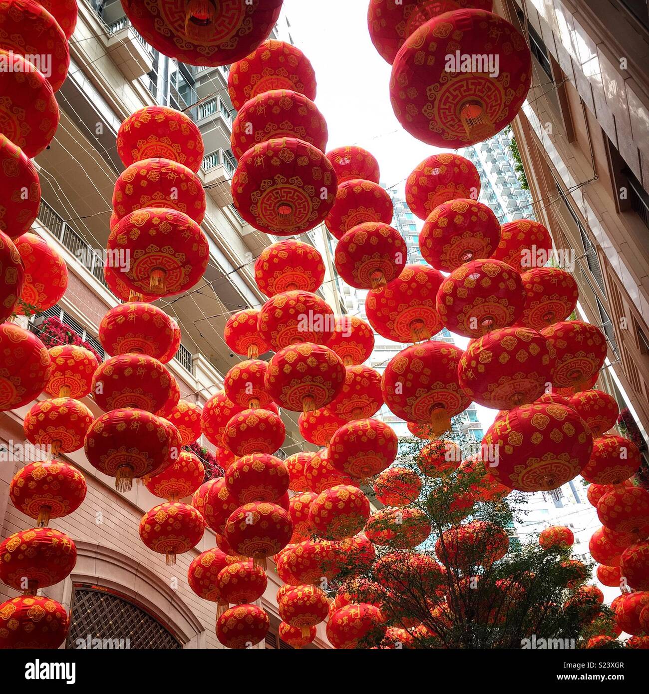 Red lanterns, traditional decorations for Chinese New Year, in Lee Tung Avenue, a shopping mall opened in 2015 on the site of old Lee Tung Street (‘Wedding Card Street’) in Wan Chai, Hong Kong - Smartphone Captured Stock Image