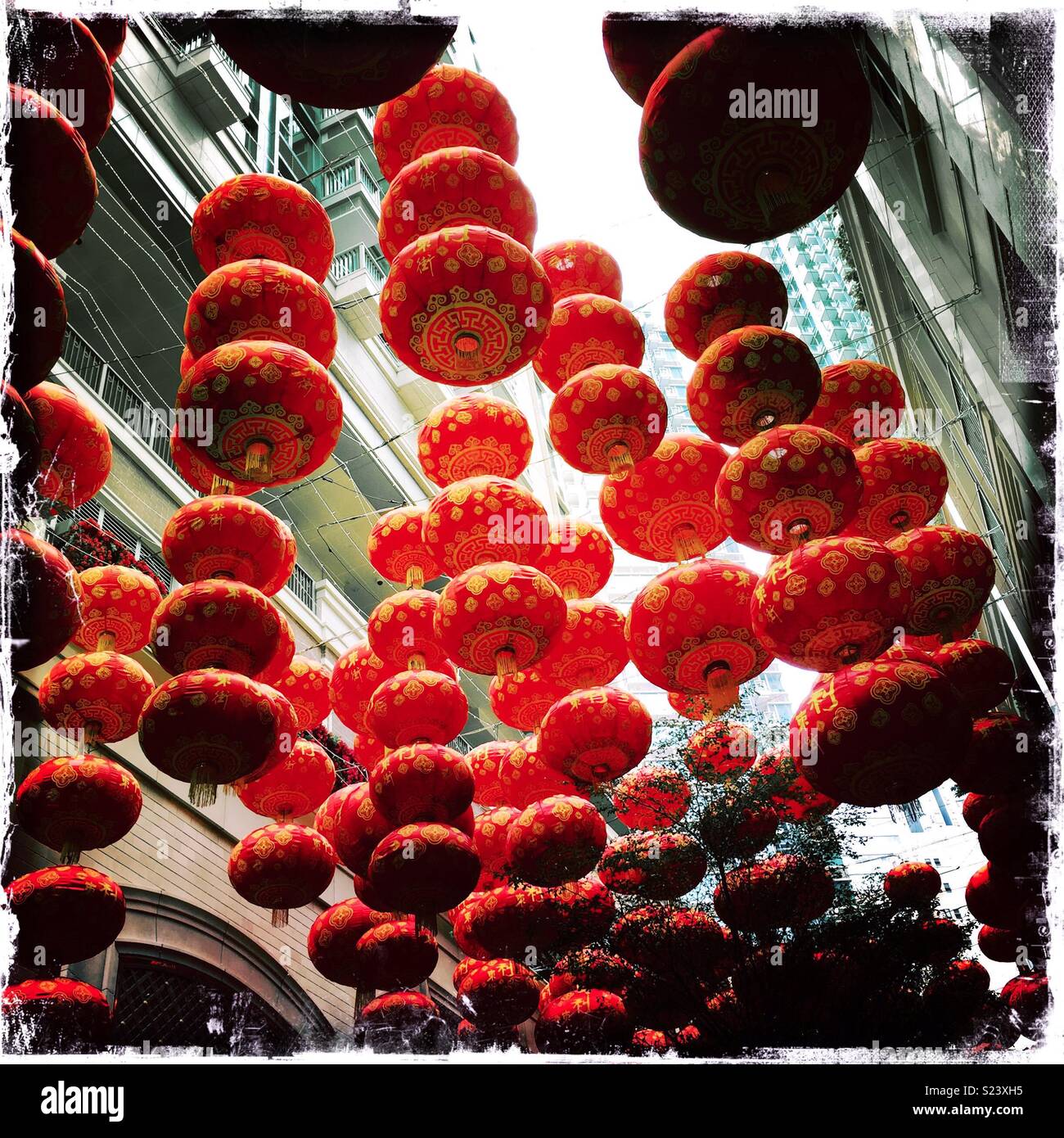 Red lanterns, traditional decorations for Chinese New Year, in Lee Tung Avenue, a shopping mall opened in 2015 on the site of old Lee Tung Street (‘Wedding Card Street’) in Wan Chai, Hong Kong - Smartphone Captured Stock Image