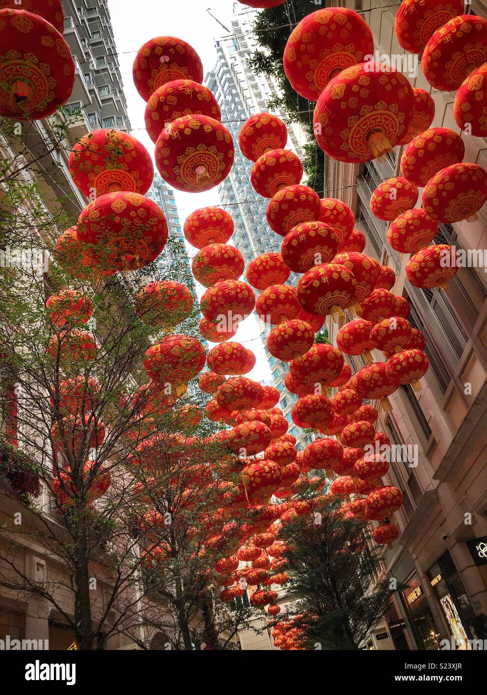 Red lanterns, traditional decorations for Chinese New Year, in Lee Tung Avenue, a shopping mall opened in 2015 on the site of old Lee Tung Street (‘Wedding Card Street’) in Wan Chai, Hong Kong - Smartphone Captured Stock Image
