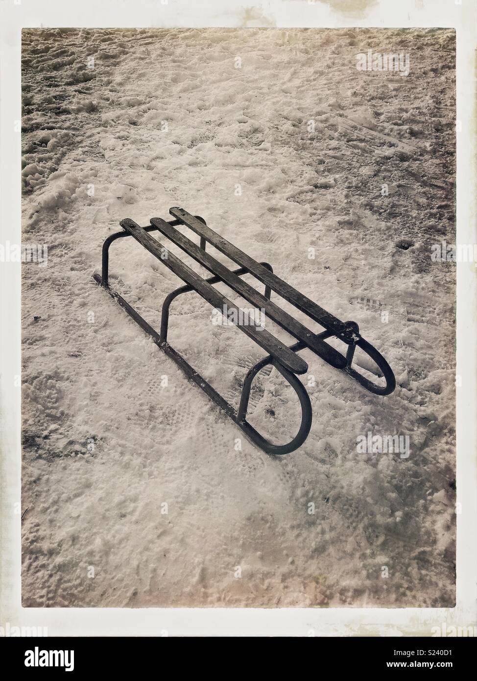 Vintage sled in the snow. - Smartphone Captured Stock Image