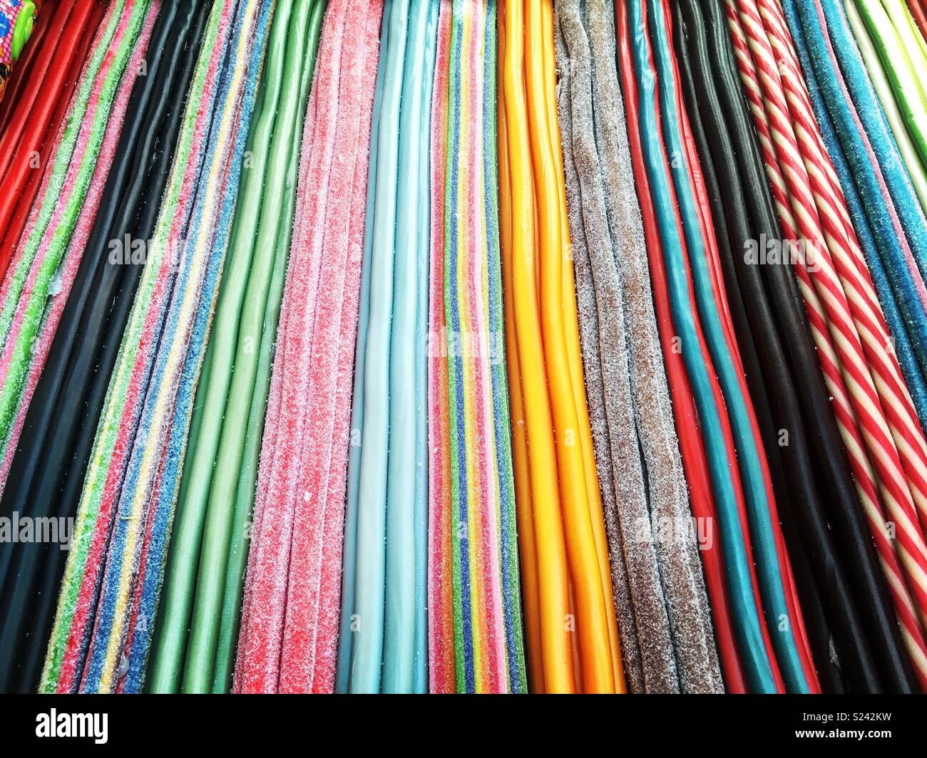 Multi colored laces and fizzy sweets Stock Photo