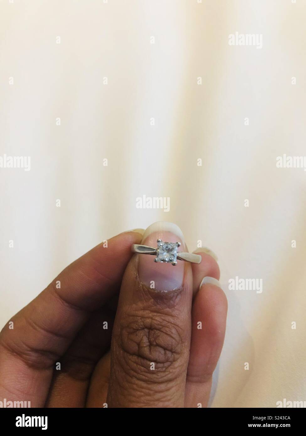 A woman holding a diamond engagement ring Stock Photo Alamy