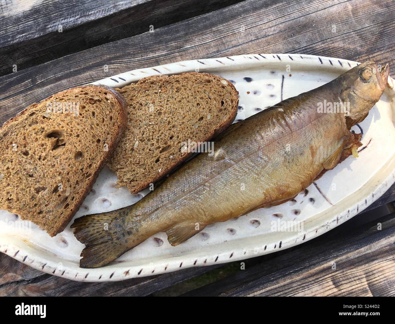 Smoked trout and whole grain bread on a plate - Smartphone Captured Stock Image