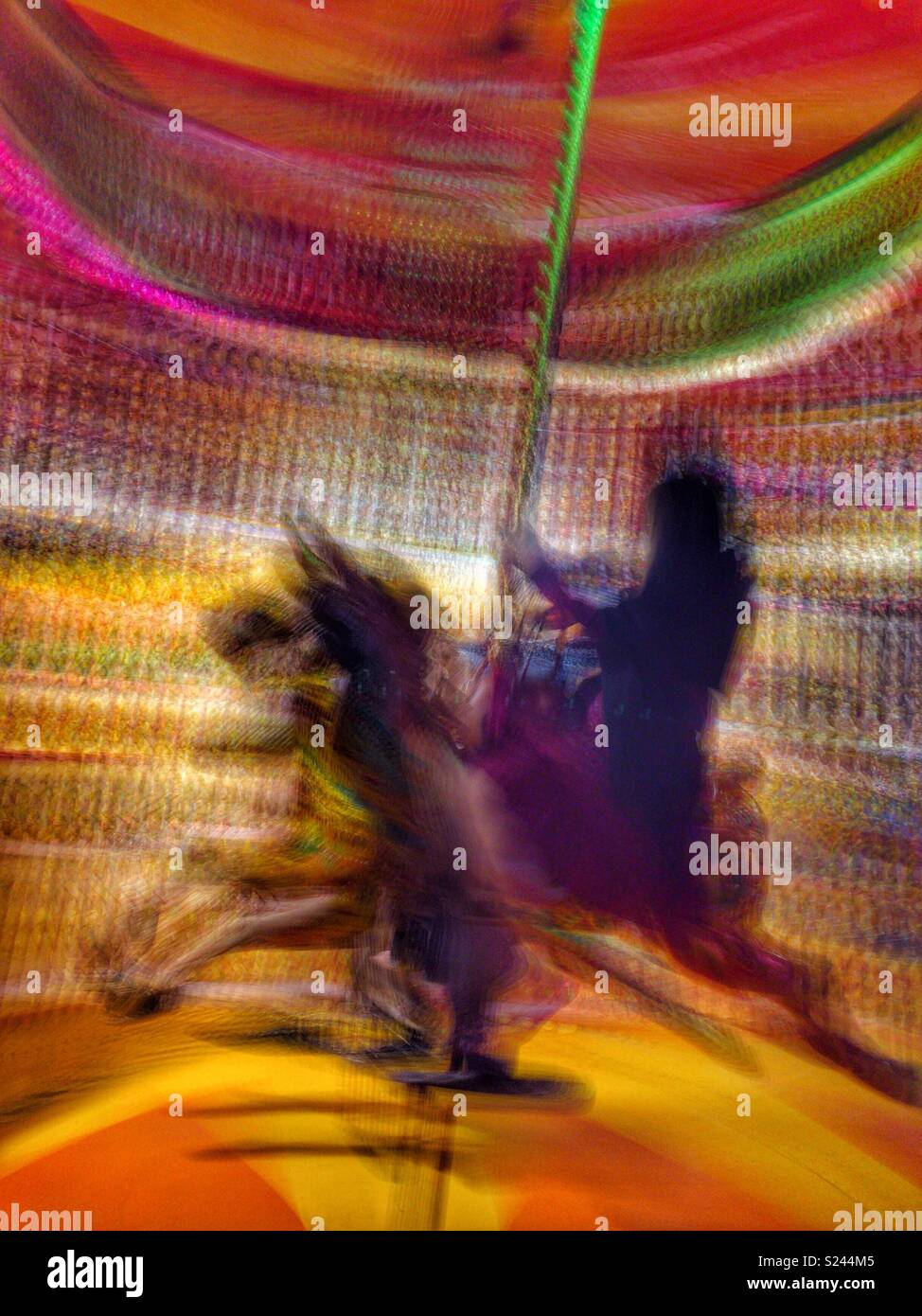 Long exposure of a girl on a merry-go-round, Central, Hong Kong Island - Smartphone Captured Stock Image
