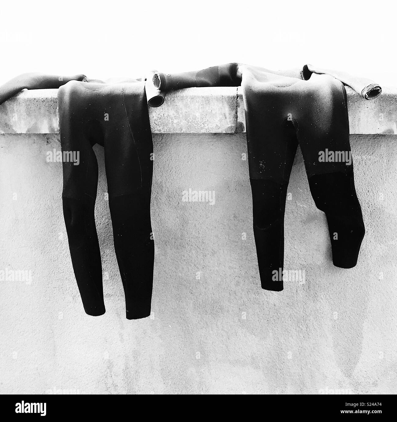 Wetsuits hanging out to dry, Cornwall, UK Stock Photo Alamy