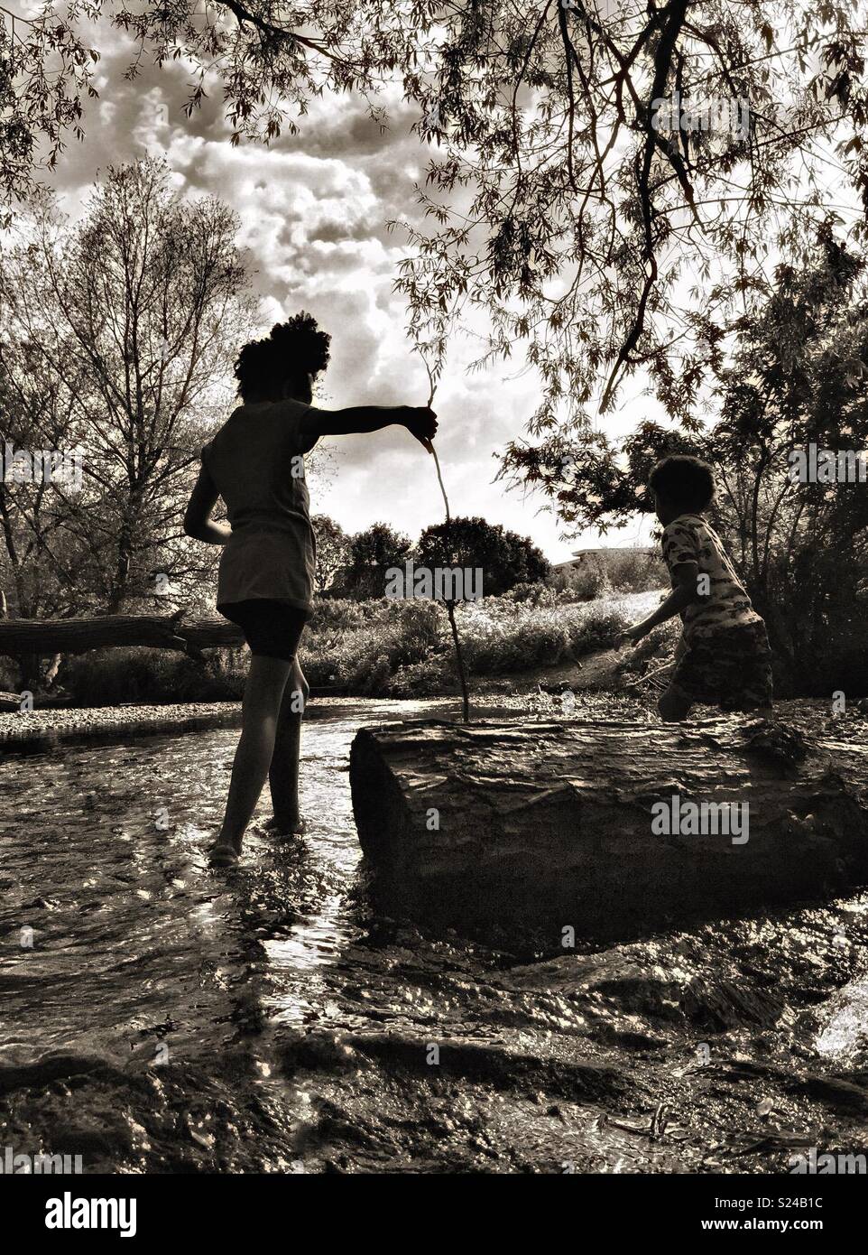 Children playing in a stream. - Smartphone Captured Stock Image