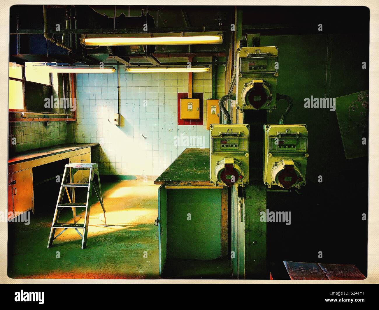 Electrical outlets and ladder in abandoned industrial building. - Smartphone Captured Stock Image