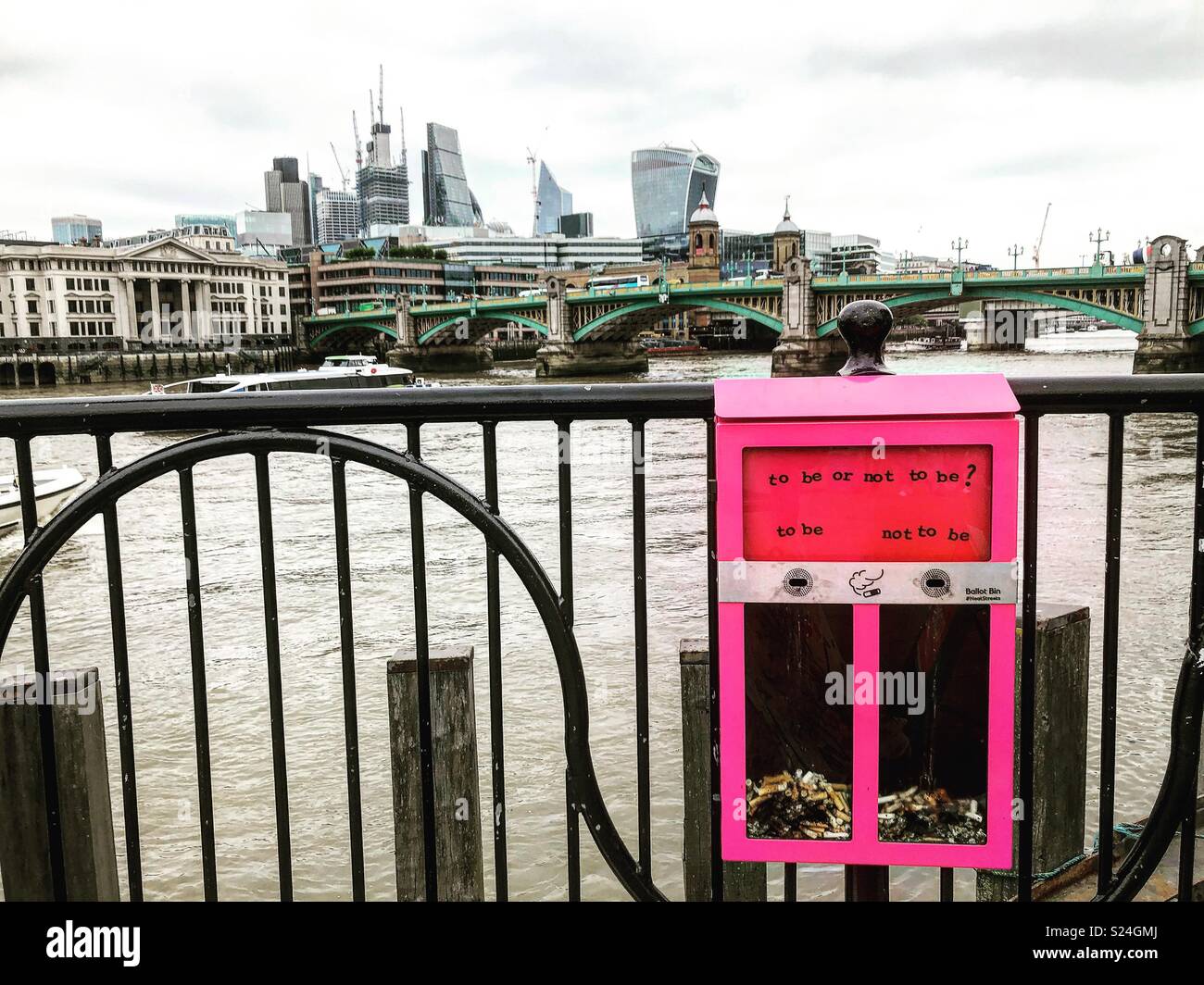 Pink ashtray with The Thames, Southwark Bridge and London City in the background Stock Photo