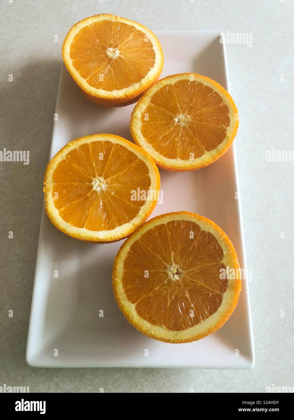 Orange slices on white tray Stock Photo