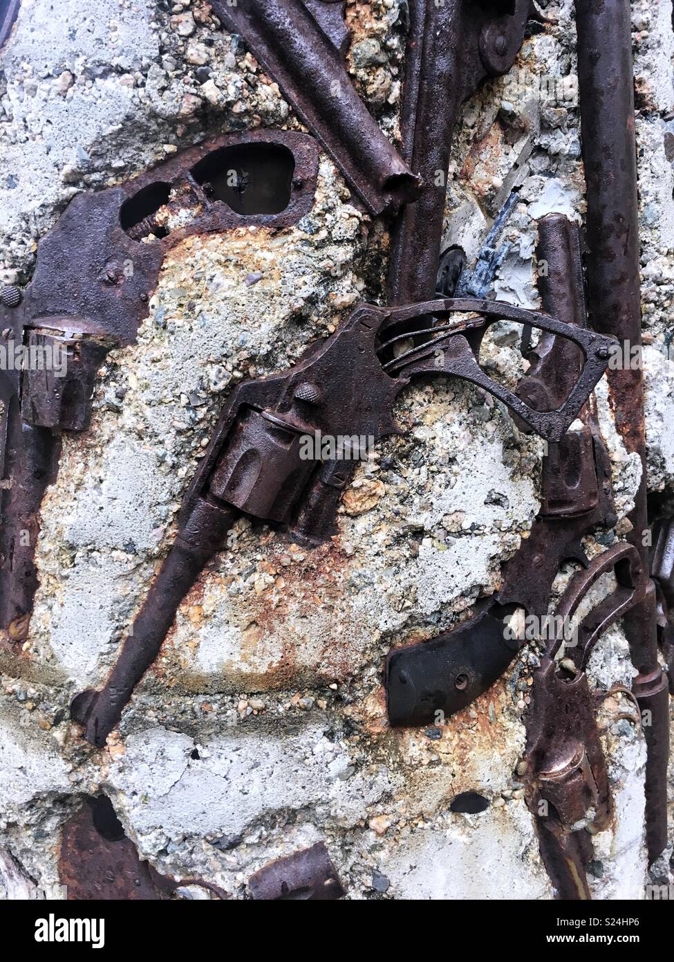 A close up of a revolver cemented in the gun totem in Providence, Rhode Island. Stock Photo