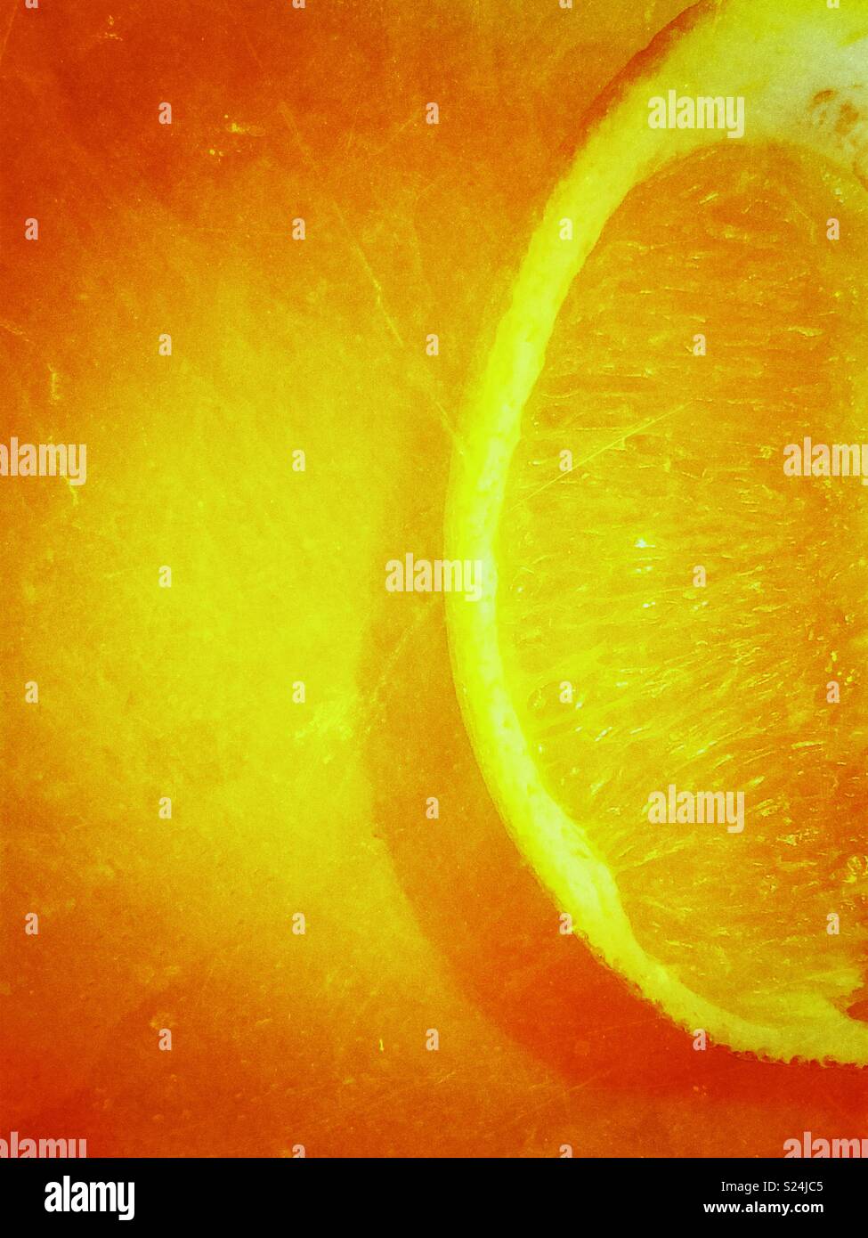 Closeup of fresh cut orange slice on cutting board with creative processing - Smartphone Captured Stock Image