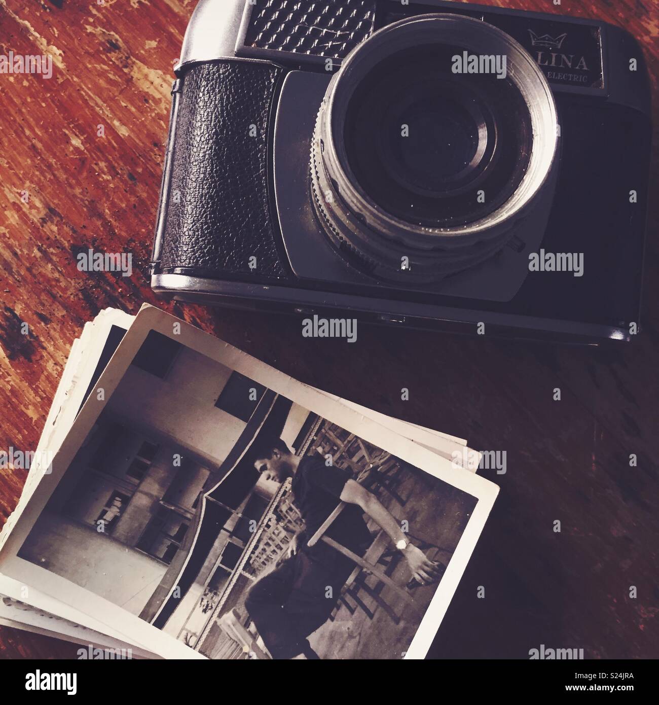 Analogue camera with a group  of pictures - Smartphone Captured Stock Image