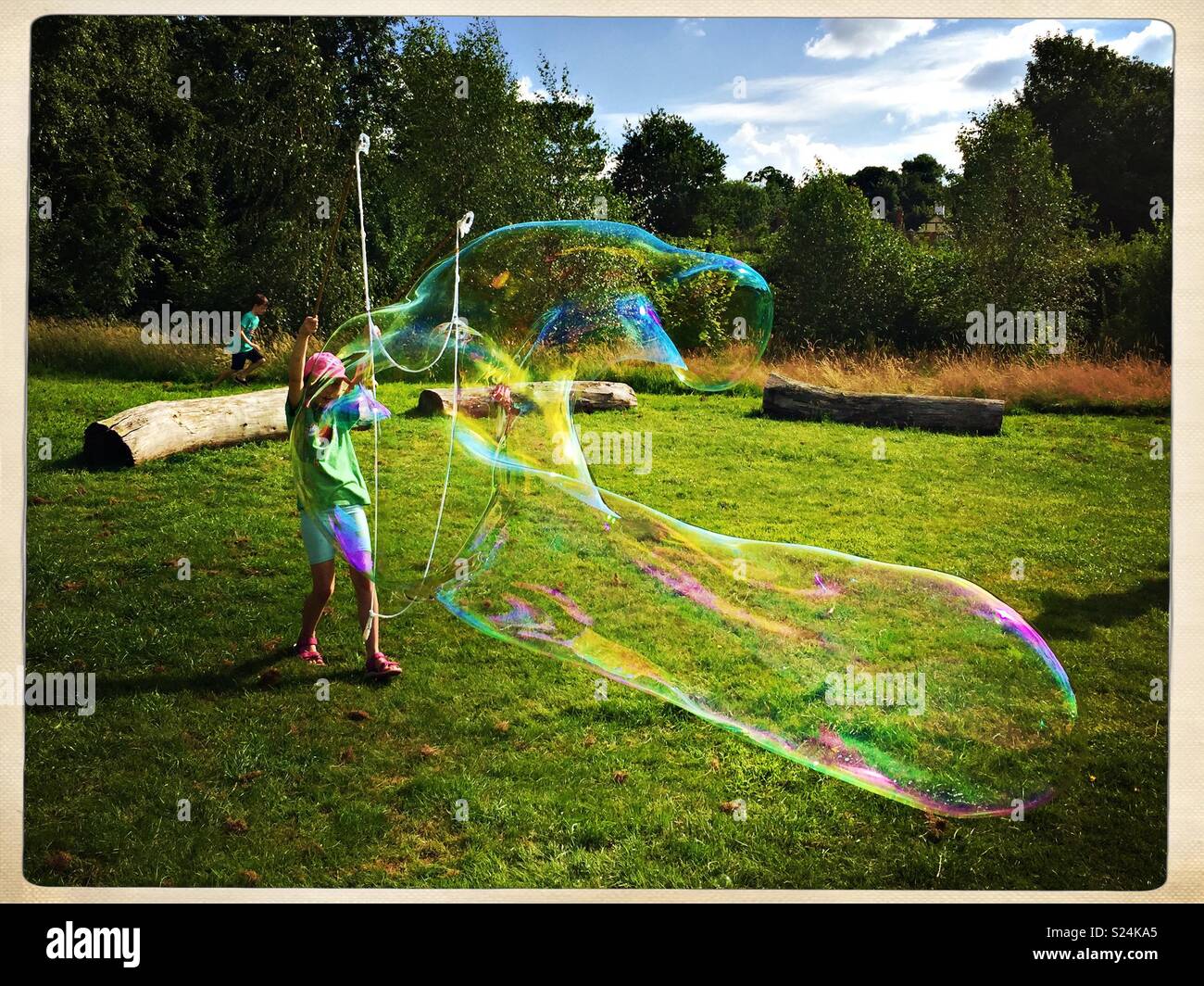Girl making giant bubble - Smartphone Captured Stock Image