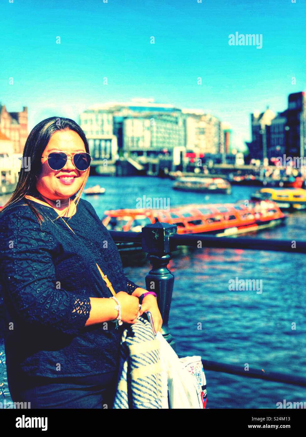 A portrait of a lady next to a canal in Amsterdam. - Smartphone Captured Stock Image
