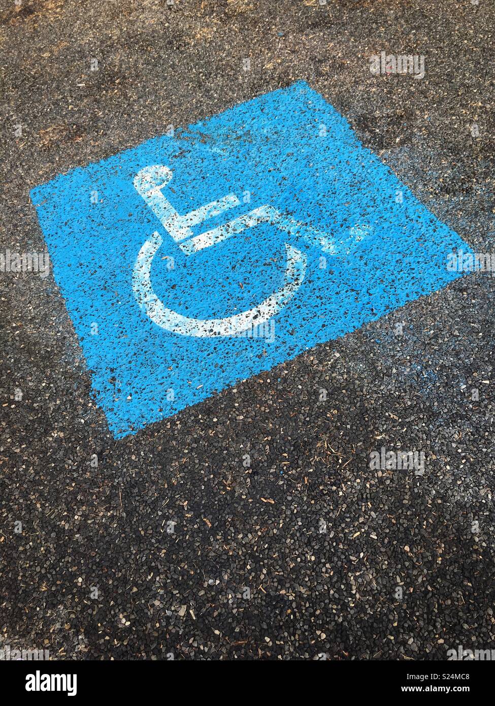 Disabled parking sign painted on the ground. Stock Photo