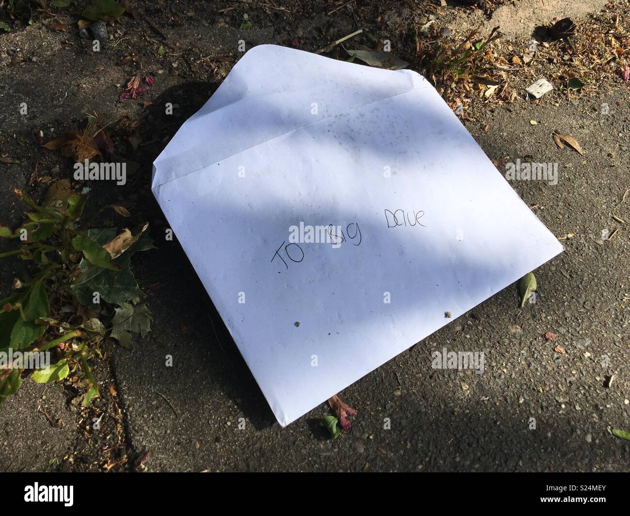An envelope addressed ‘to big Dave’ dropped in the street - Smartphone Captured Stock Image