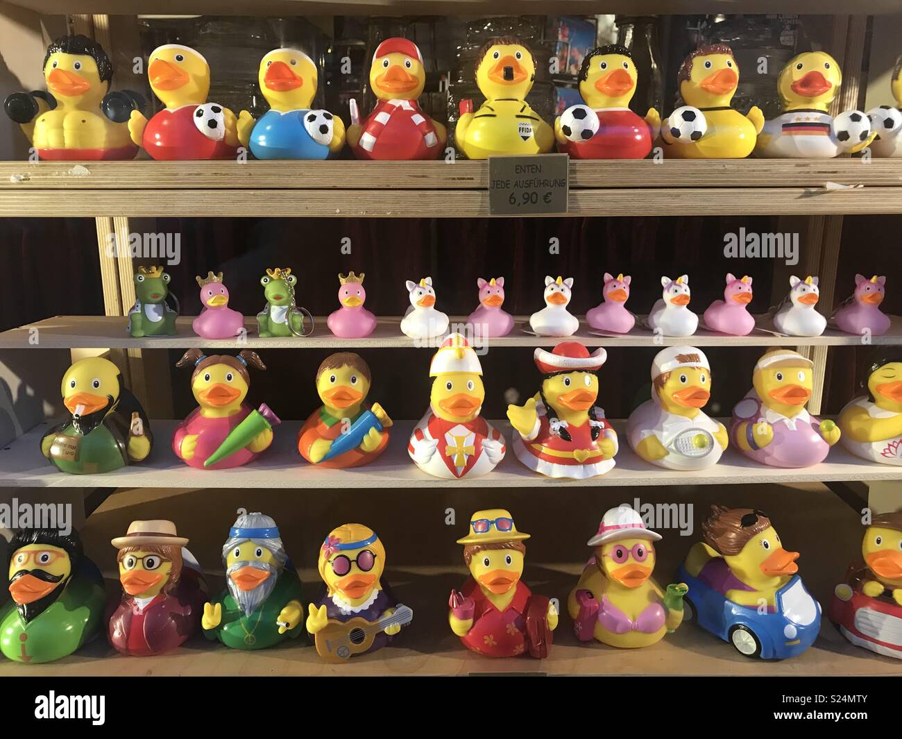Rubber ducks in costume on shelves.  Footballers and fairytale figures Stock Photo