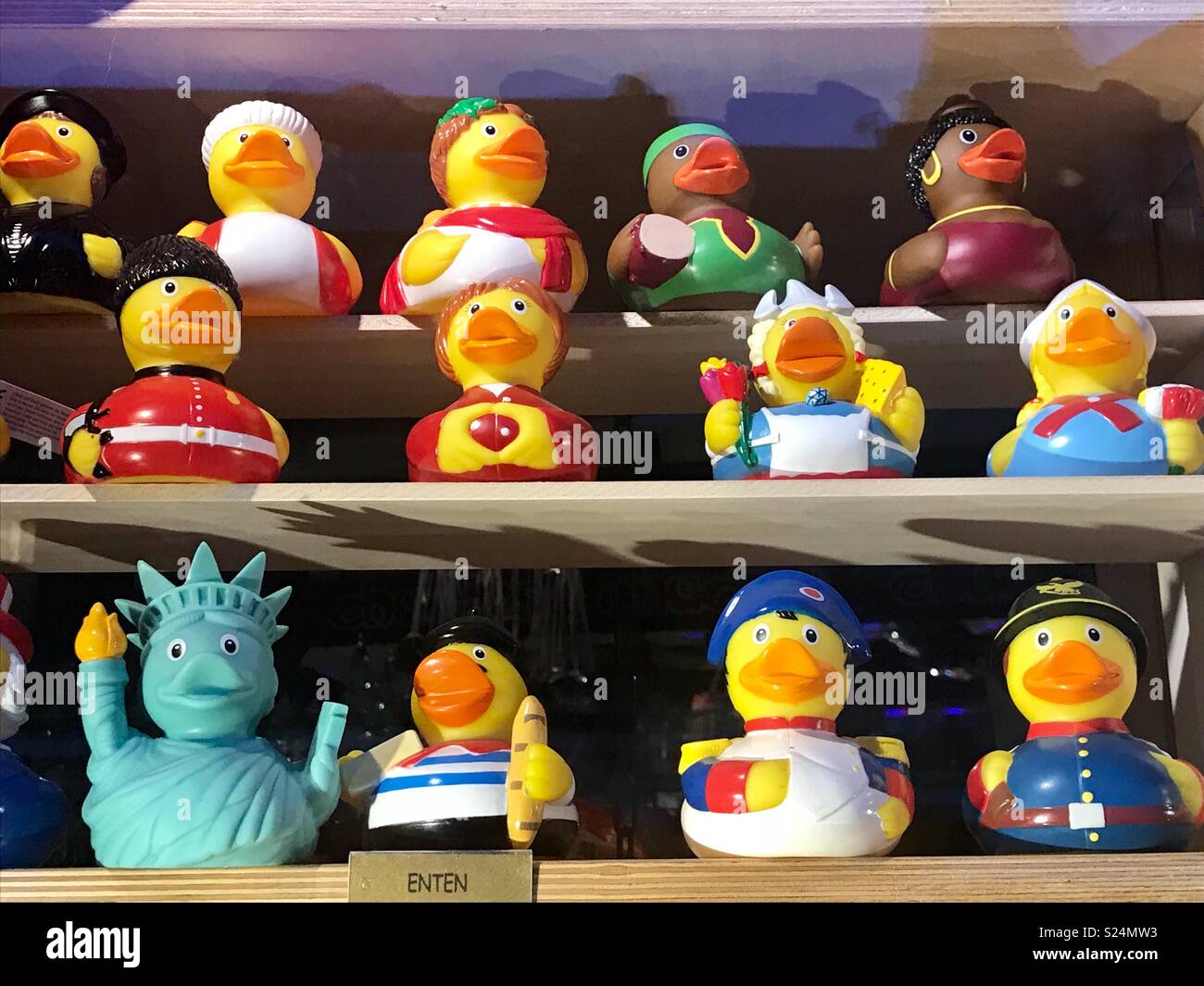 Rubber ducks in costume on shelves. Statue of Liberty, policeman, Napoleon and fireman Stock Photo