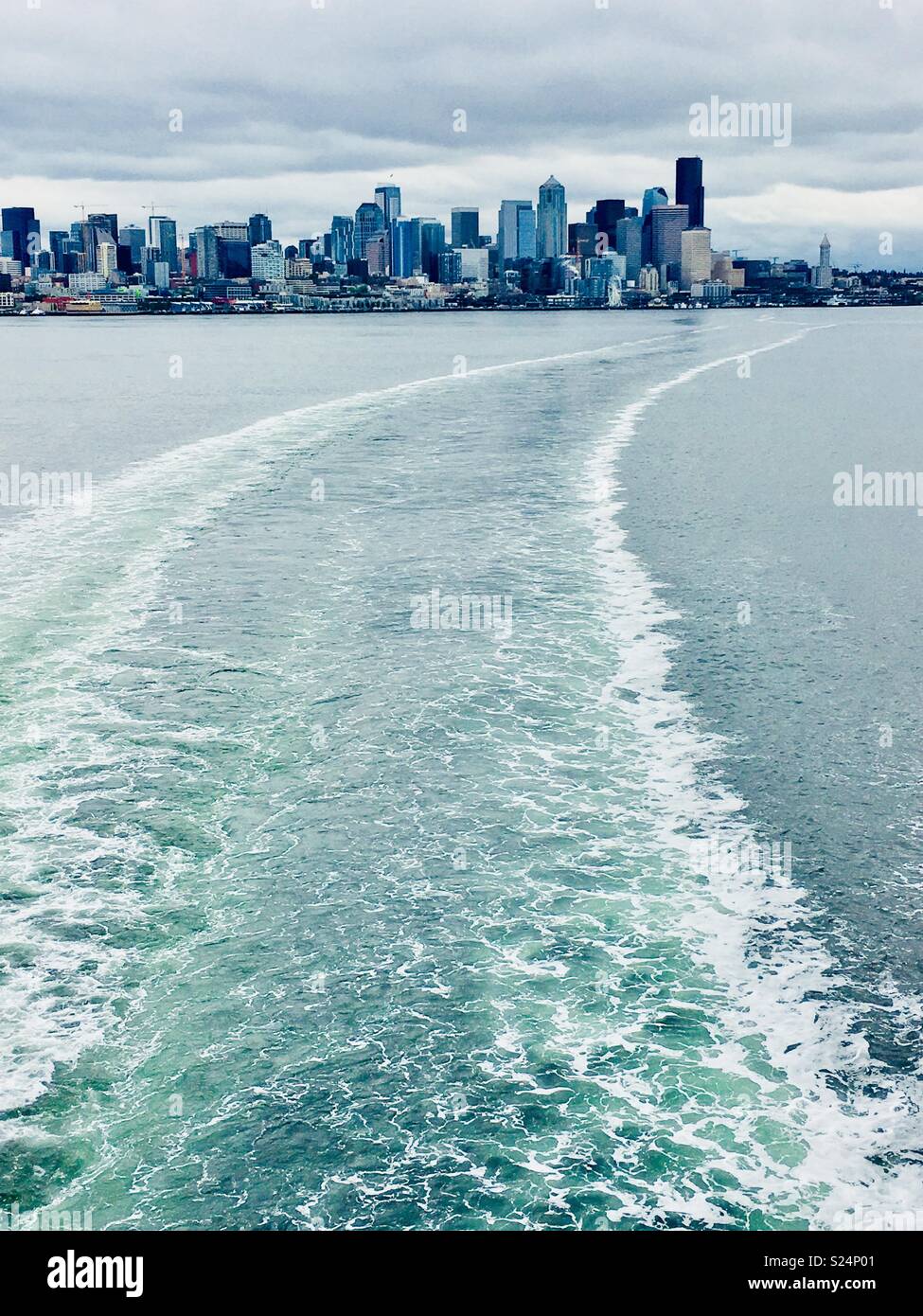 Bainbridge Ferry boat wake on Puget Sound with skyline of Seattle, Wa USA Stock Photo