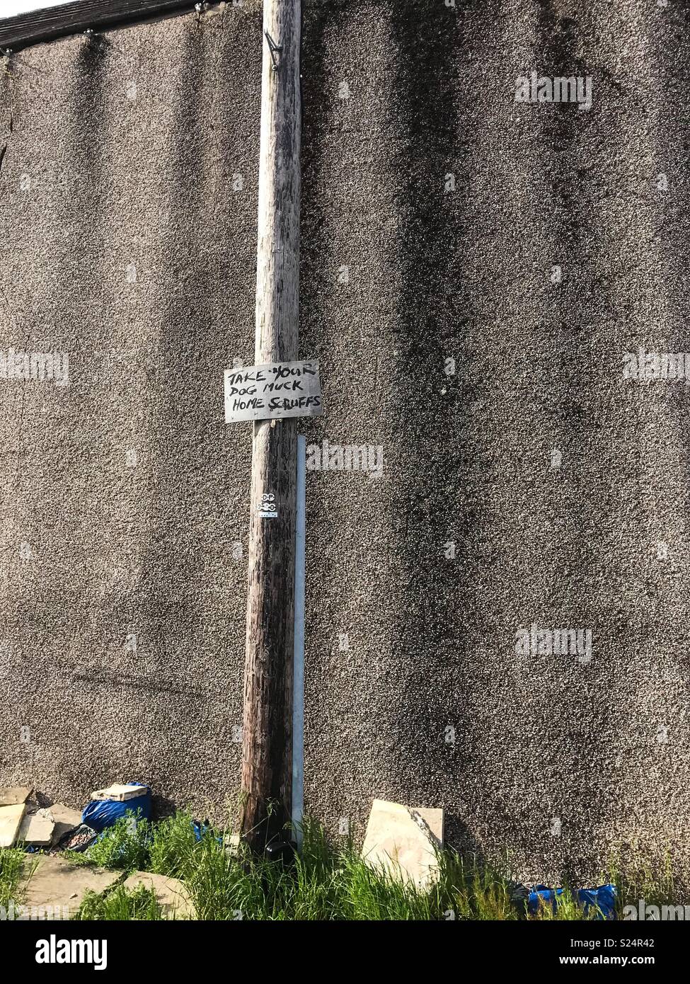 Take your dog muck away sign hand written on a lamppost - Smartphone Captured Stock Image