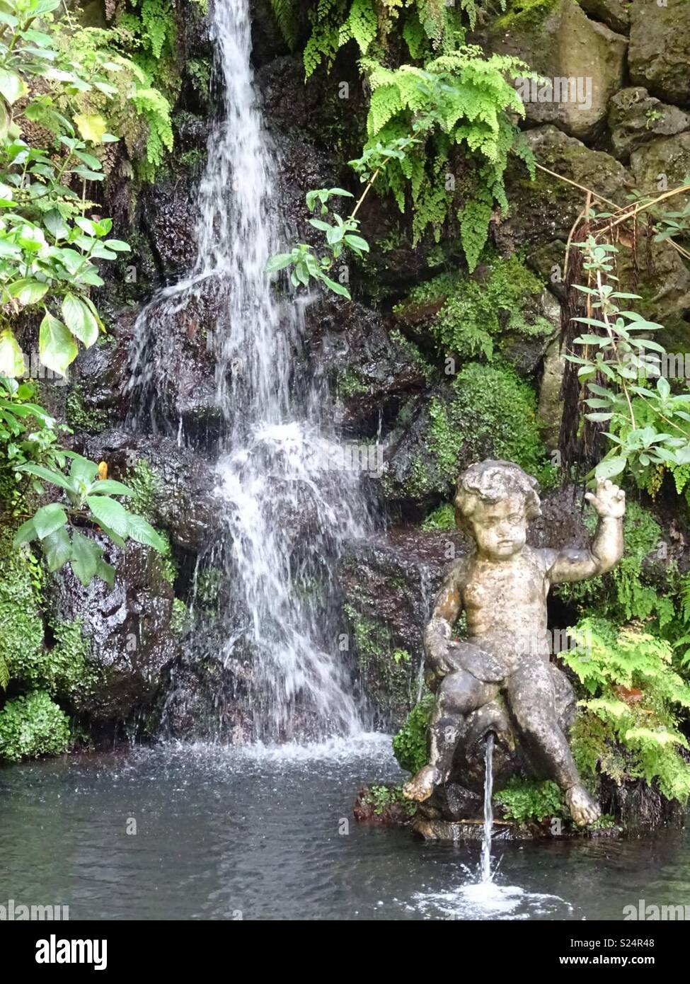 Waterfall with statue Stock Photo Alamy