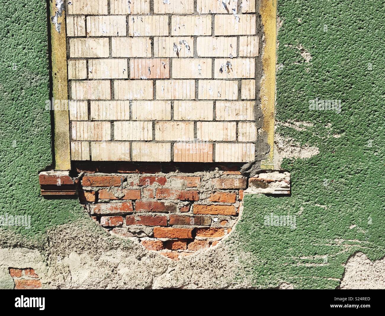 A bricked up window in a green wall - Smartphone Captured Stock Image