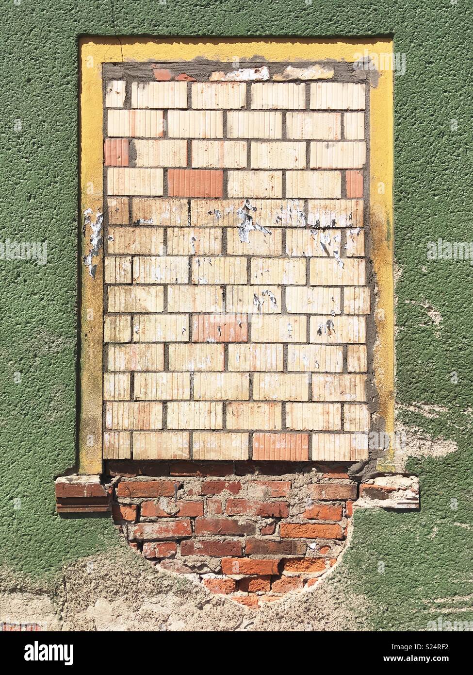 A bricked up window in a green wall - Smartphone Captured Stock Image