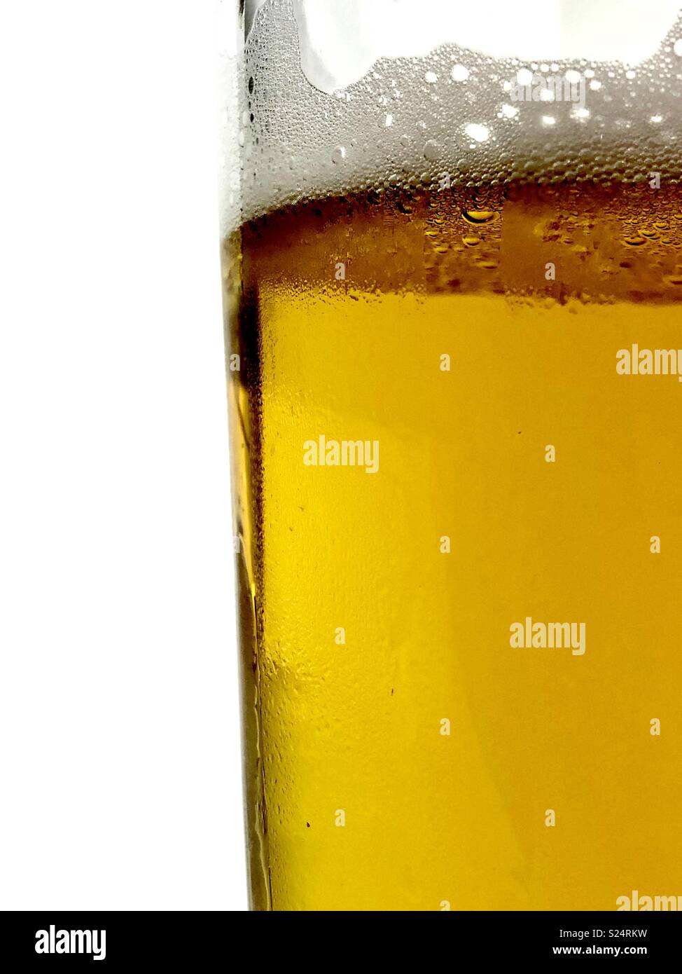 Close up of a glass of beer against a white background - Smartphone Captured Stock Image