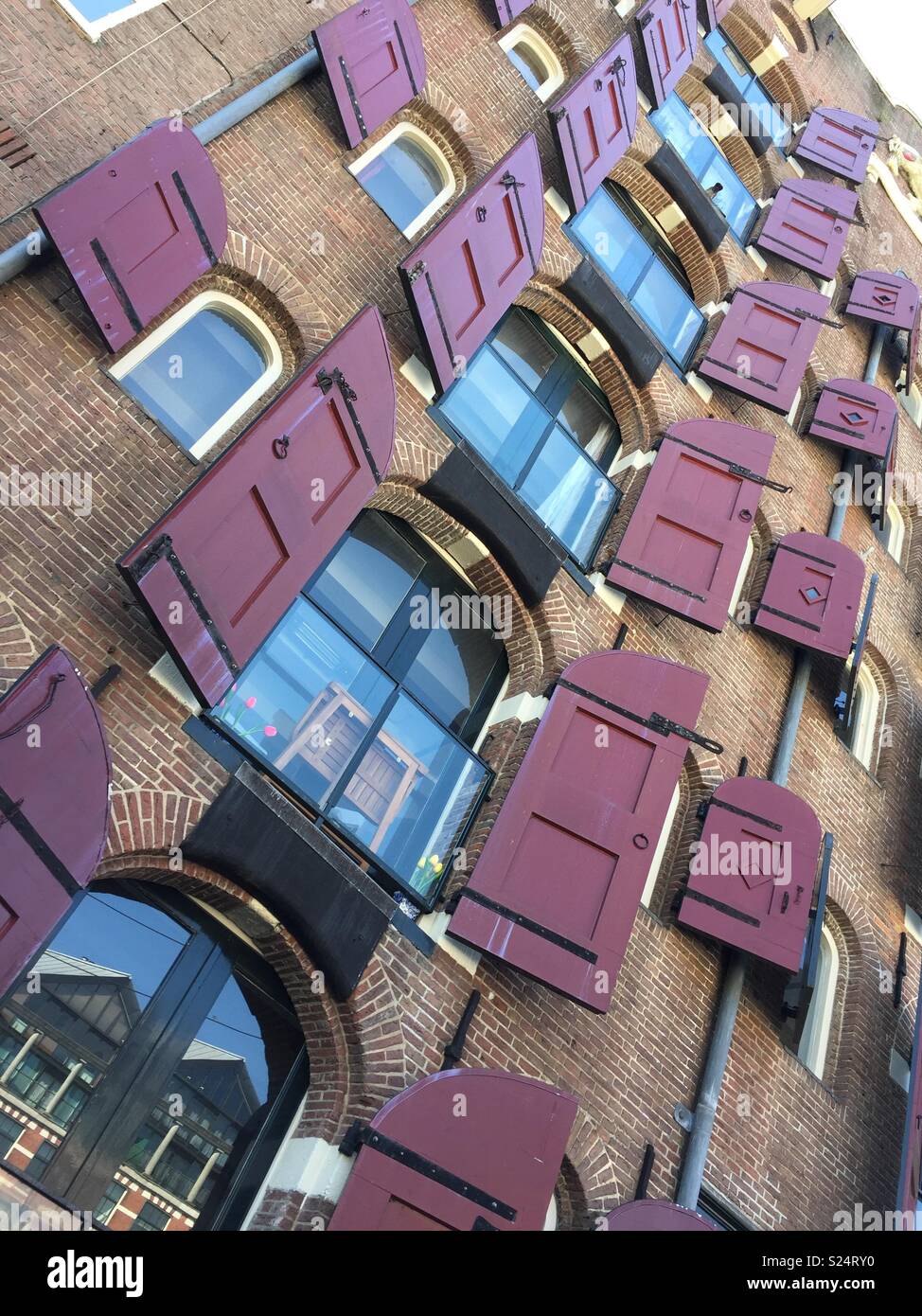 Window shutters in a traditional style on a retro Amsterdam building - Smartphone Captured Stock Image