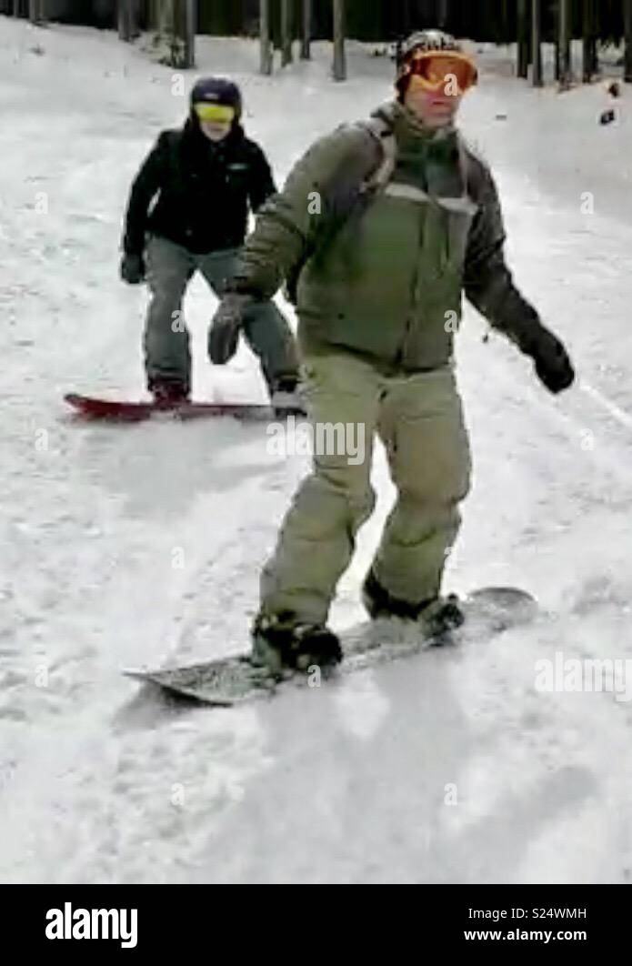 Brothers snowboarding in Bansko, Bulgaria. Winter fun on the slopes Stock Photo
