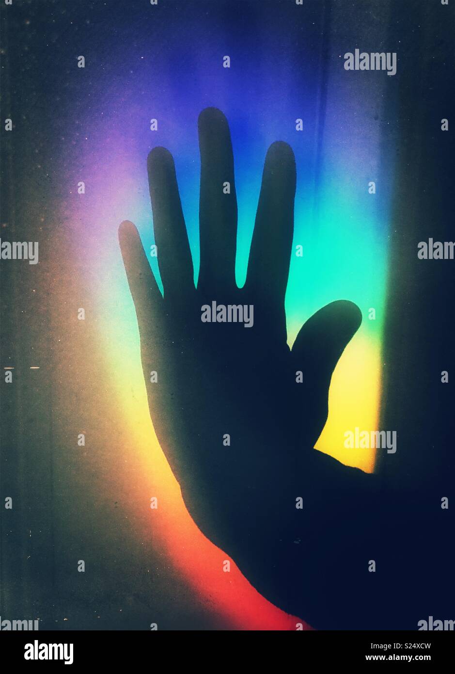 Person’s hand silhouette shadows against rainbow light - Smartphone Captured Stock Image