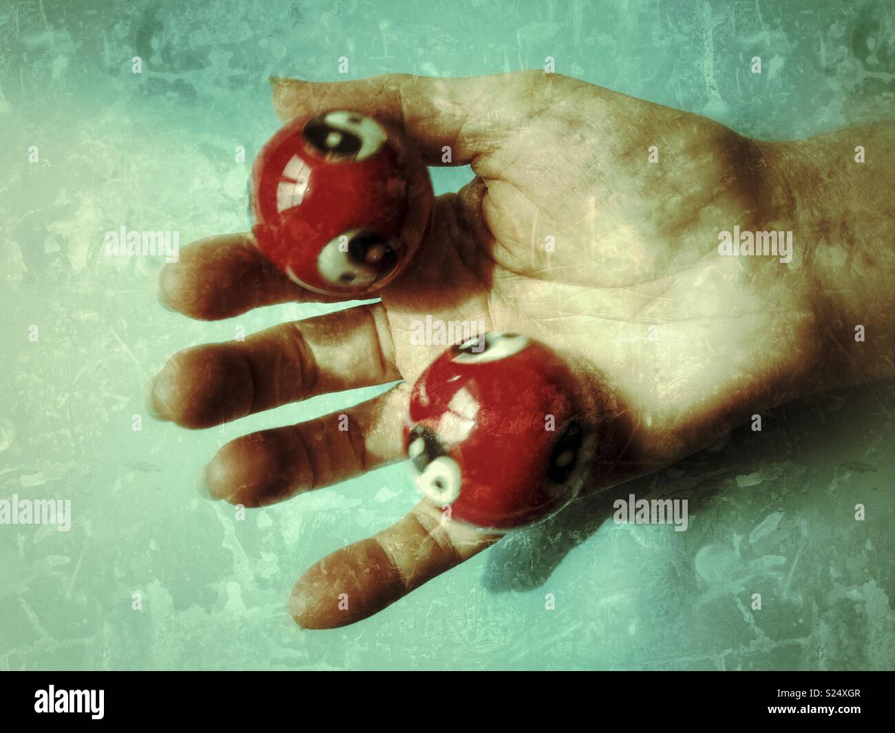 Stress Relief. Tai chi balls, also known as Yin Yang balls, in a woman’s hand. Stock Photo