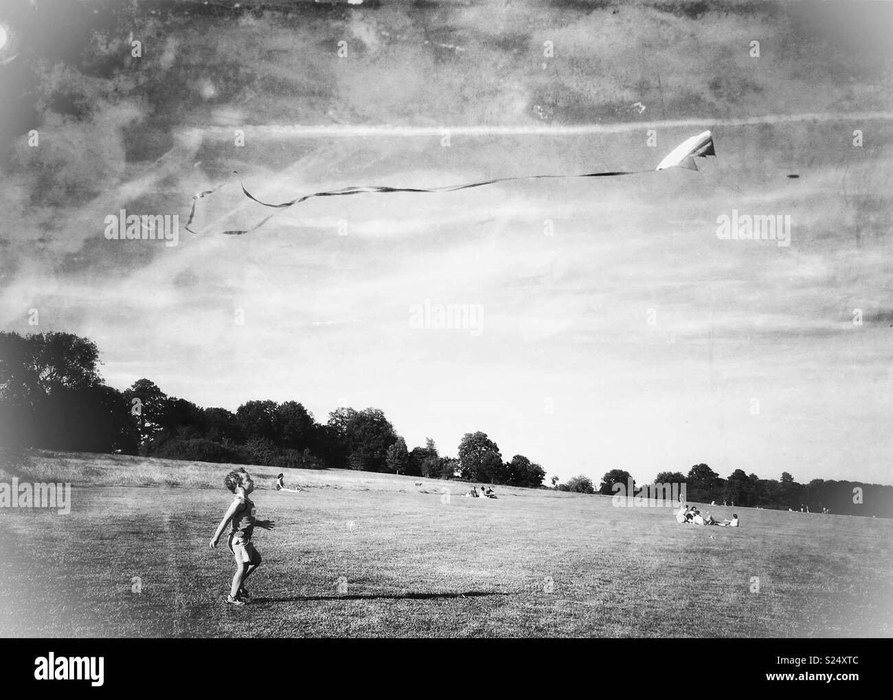 A boy chasing kite on Hampstead Heath Stock Photo