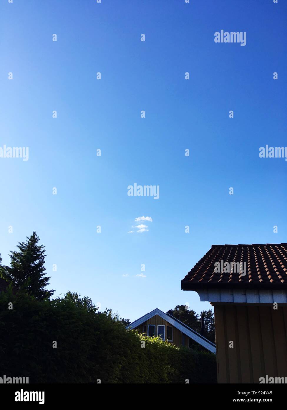 A suburban house and blue sky - Smartphone Captured Stock Image
