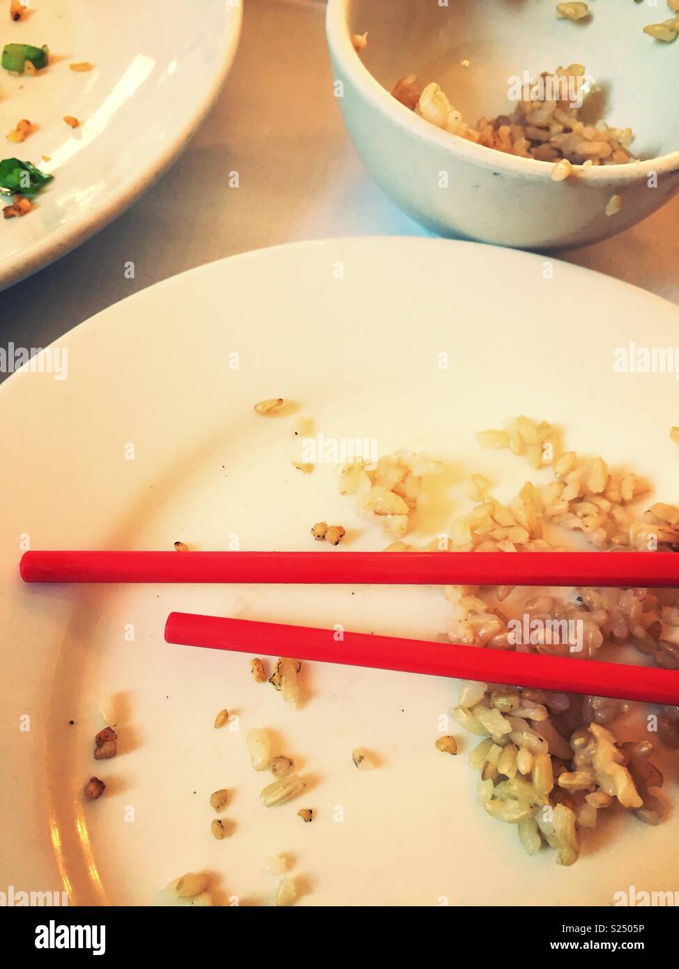 Empty plates and chopsticks after a meal in a Chinese restaurant, Chinatown, NYC, USA - Smartphone Captured Stock Image