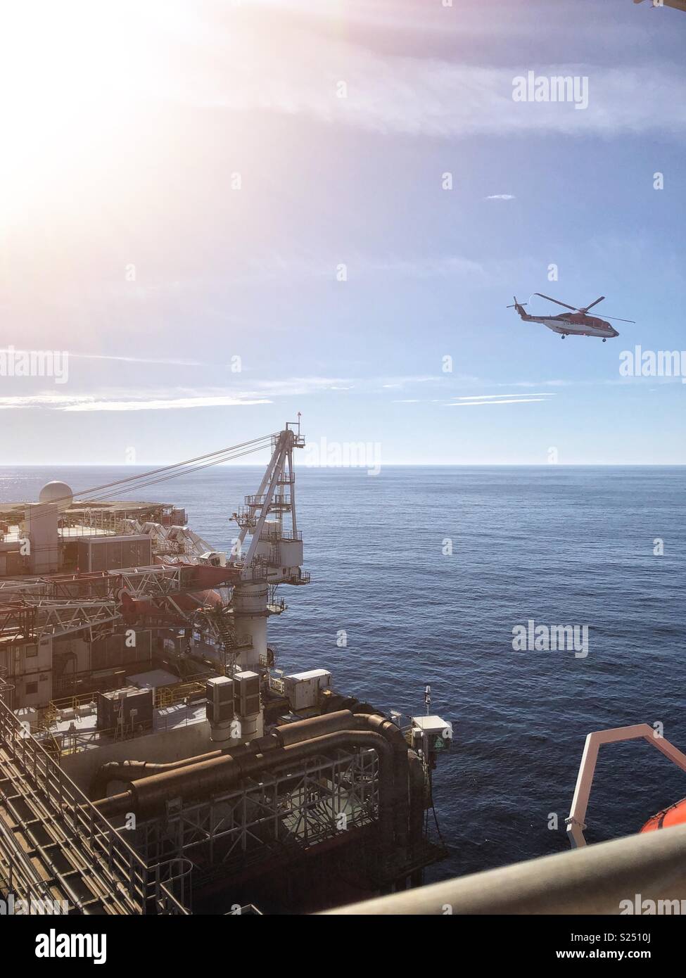 Helicopter leaving North Sea oil and gas rig: credit Lee Ramsden / Alamy Stock Photo
