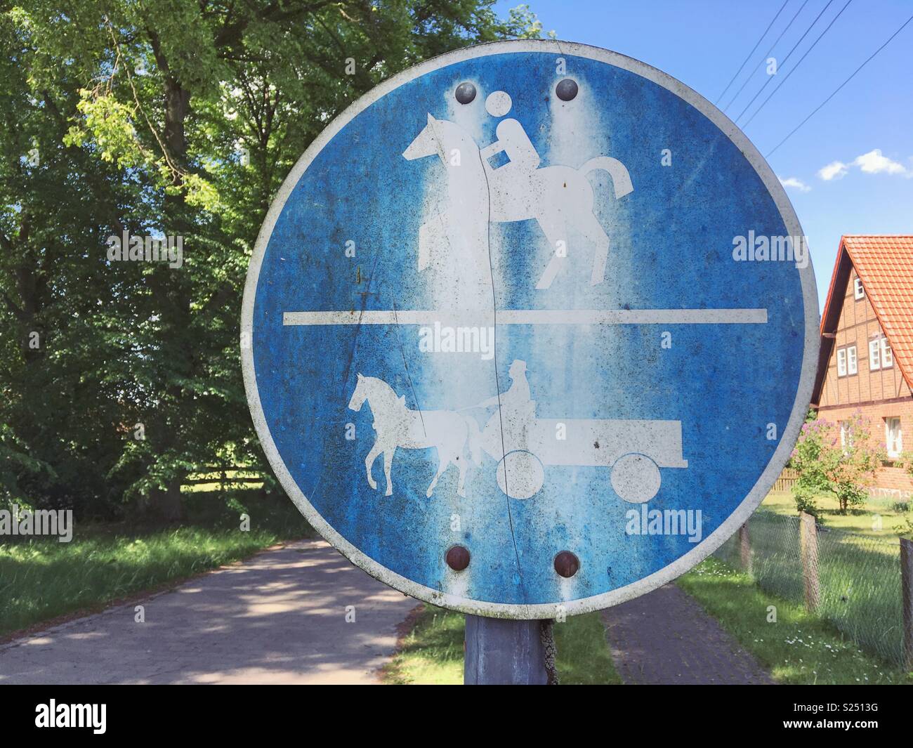 A weathered traffic sign indicating a horse and Horse carriage or buggy path in Mecklenburg-Vorpommern, Germany Stock Photo