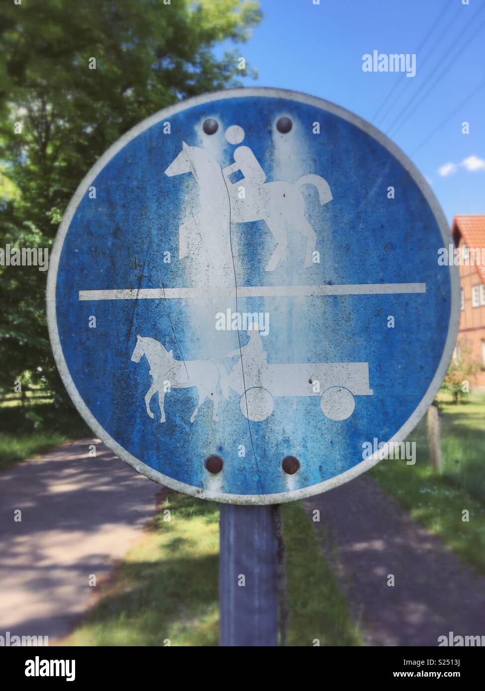 A weathered traffic sign indicating a horse and Horse carriage or buggy path in Mecklenburg-Vorpommern, Germany Stock Photo