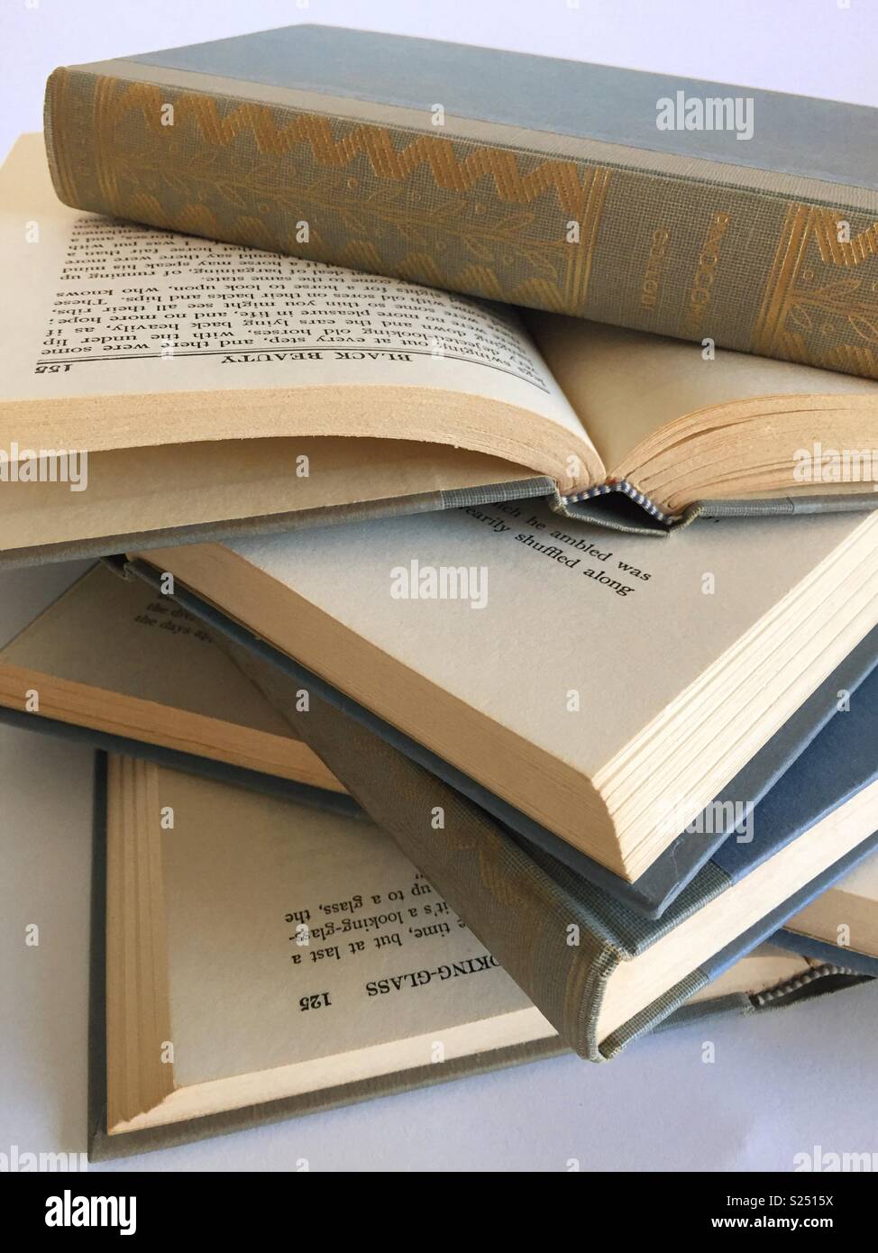 Close up of a stack of opened vintage books - Smartphone Captured Stock Image