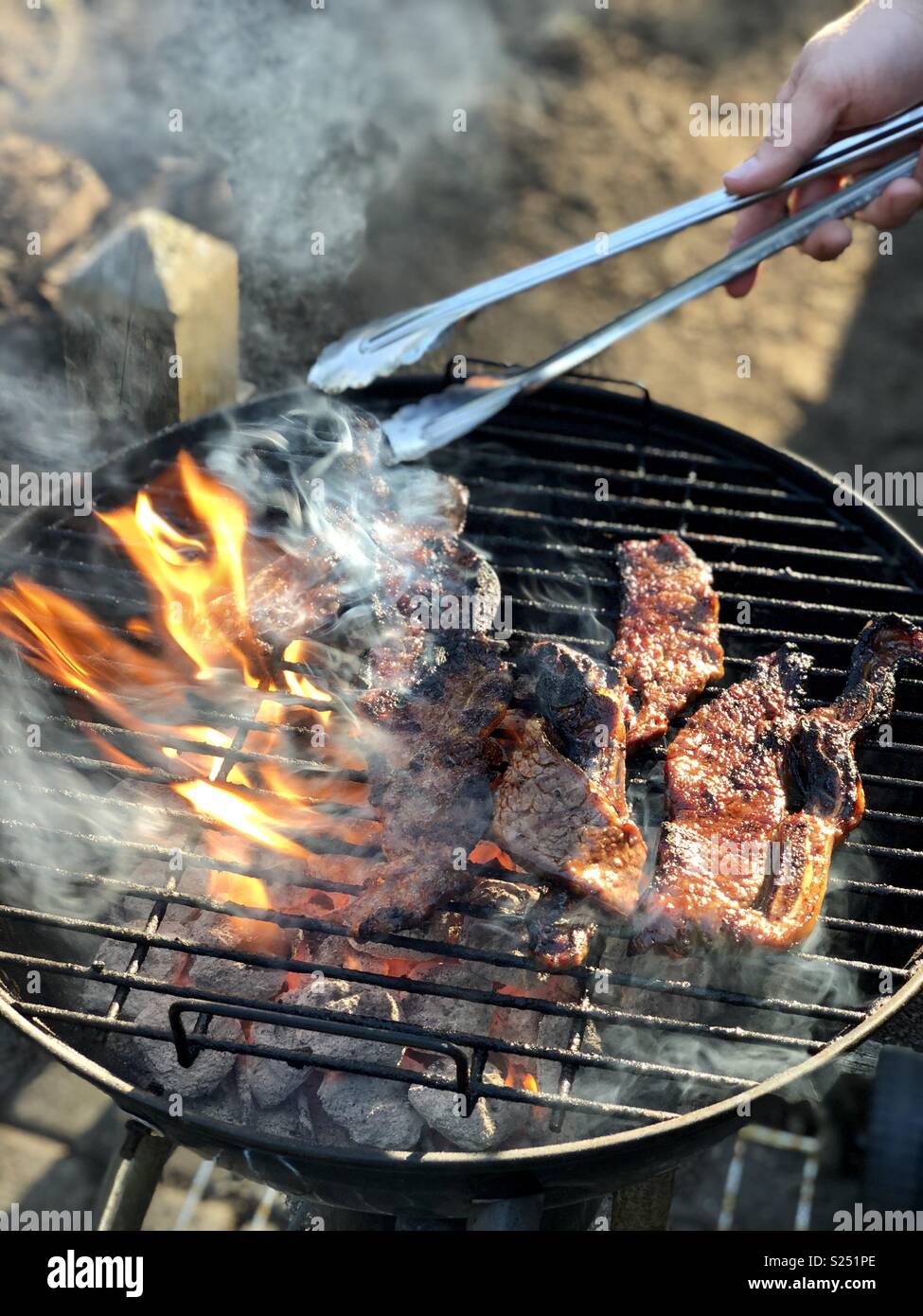 Meat on charcoal barbecue Stock Photo - Alamy