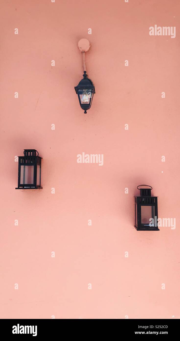 Lanterns on a peach coloured wall in Malcesine, Italy. - Smartphone Captured Stock Image