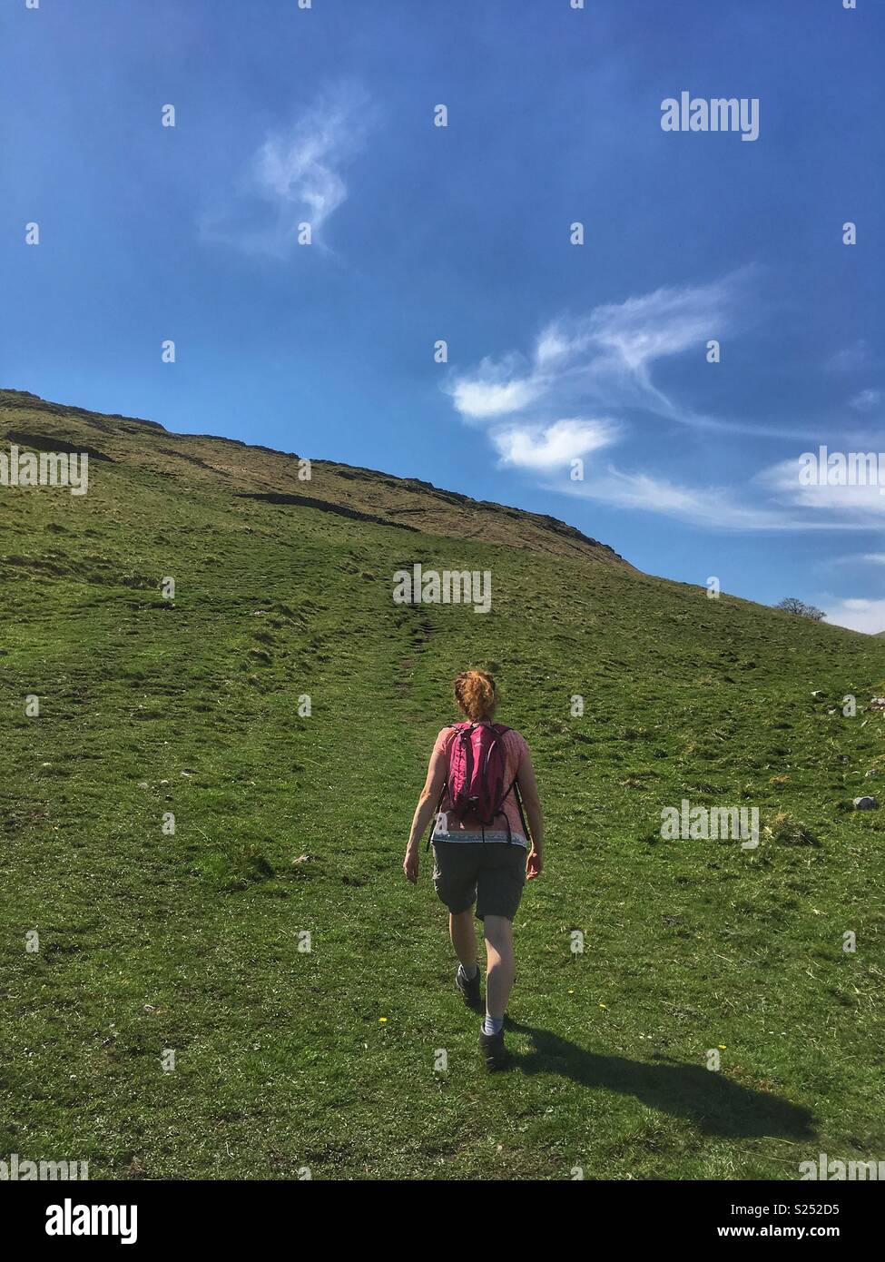 A woman walking in the Yorkshire Dales on a sunny day - Smartphone Captured Stock Image