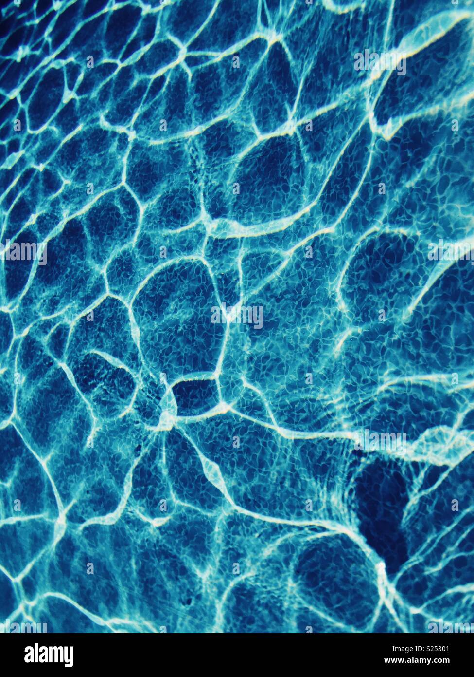 Underwater light reflections in an outdoor swimming pool Stock Photo