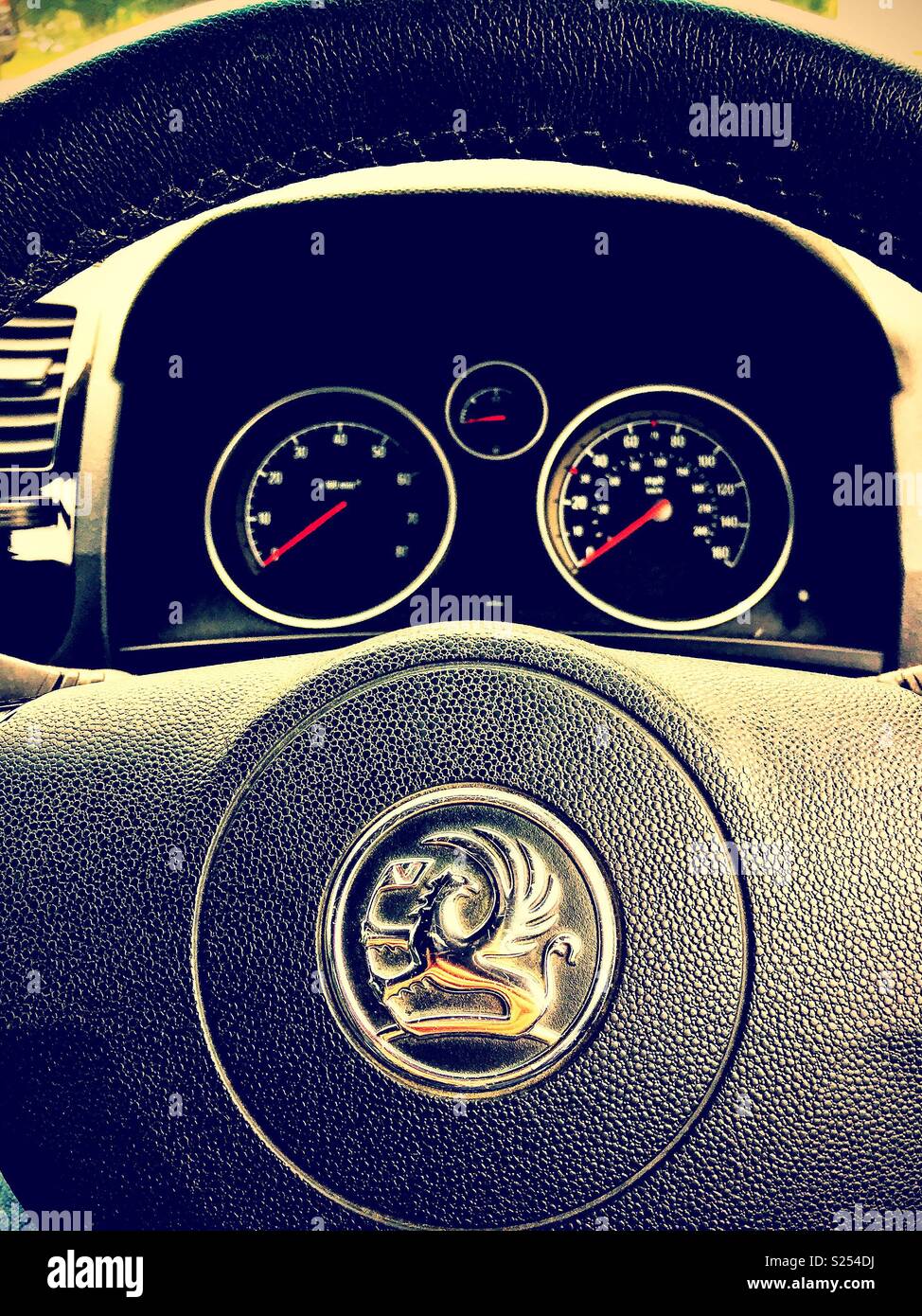 Sitting behind the steering wheel of a Vauxhall car. - Smartphone Captured Stock Image