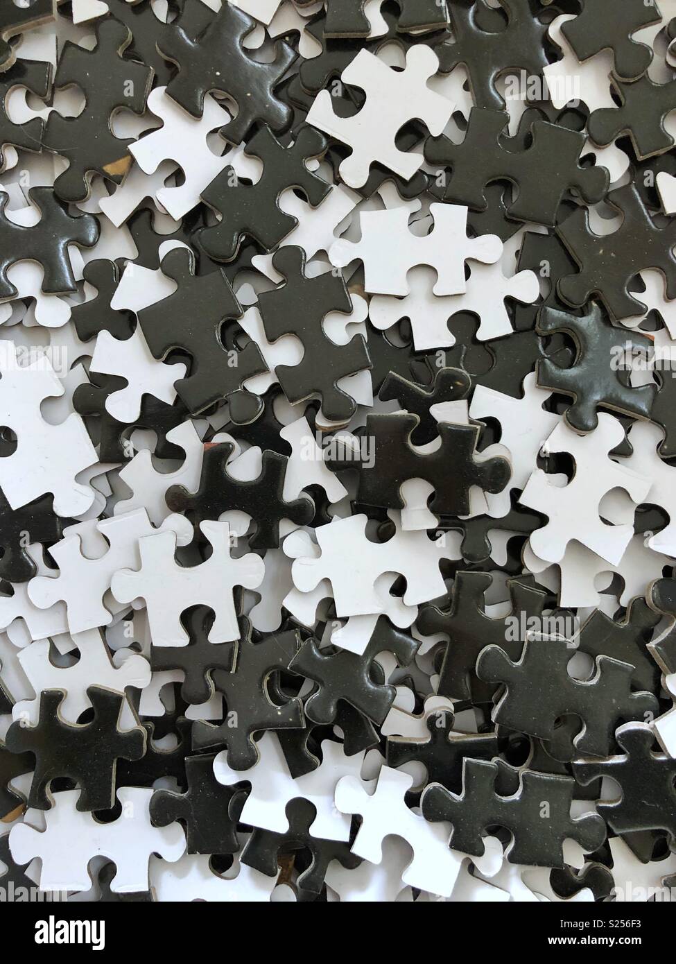 Black and white jigsaw puzzle pieces. - Smartphone Captured Stock Image